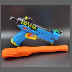 May include: A blue and black toy blaster with a yellow trigger and the word "RIVAL" printed on the side. The blaster is attached to an orange barrel extension.