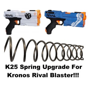 May include: Two toy blasters, one white and orange, the other blue and orange, with a black spring. The blasters have the word "RIVAL" printed on them. The text at the bottom reads "K25 Spring Upgrade For Kronos Rival Blaster!!!"