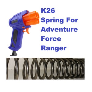 May include: A black metal spring for a toy gun. The spring is coiled and has a shiny finish. The text "K26 Spring For Adventure Force Ranger" is visible in the image.