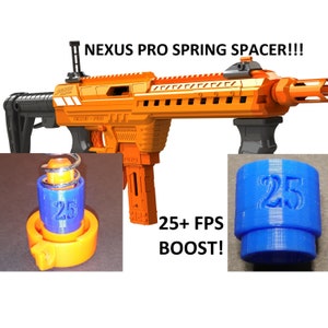 May include: Orange and black Nerf Nexus Pro blaster with a blue and orange spring spacer. The spacer is labeled "25" and is designed to increase the blaster's velocity by 25+ FPS. "NEXUS PRO" and "PRO" are printed on the blaster.