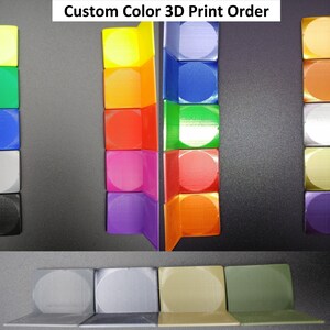May include: Custom Color 3D Print Order.  A visual guide to different colors of 3D printed plastic.  The colors are arranged in columns, with each column showing a different shade of the same color.  The colors are: green, yellow, blue, orange, gray, silver, gold, purple, and red.