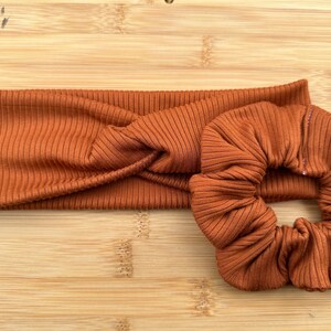 May include: A brown ribbed headband and a matching brown ribbed scrunchie.