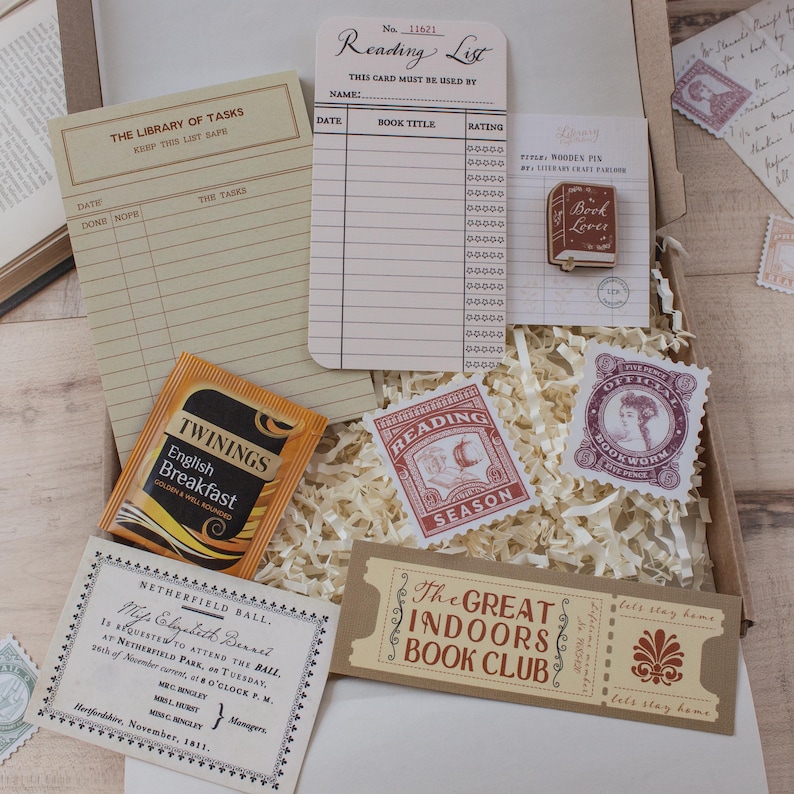 May include: A stationery gift box containing a Library of Tasks notepad, a Reading List card, a wooden Book Lover pin, a Twinings English Breakfast tea bag, a Reading Season sticker, a Bookworm stamp, a Netherfield Ball invitation, and a ticket.