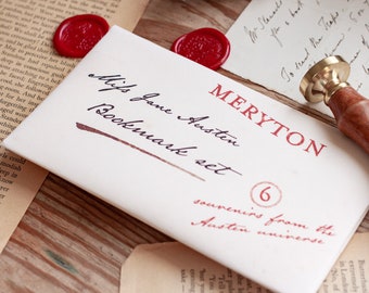 May include: A white envelope with red wax seals and the text "MERYTON Miss Jane Austen Bookmark set 6 souvenirs from the Austen universe" written in black ink.