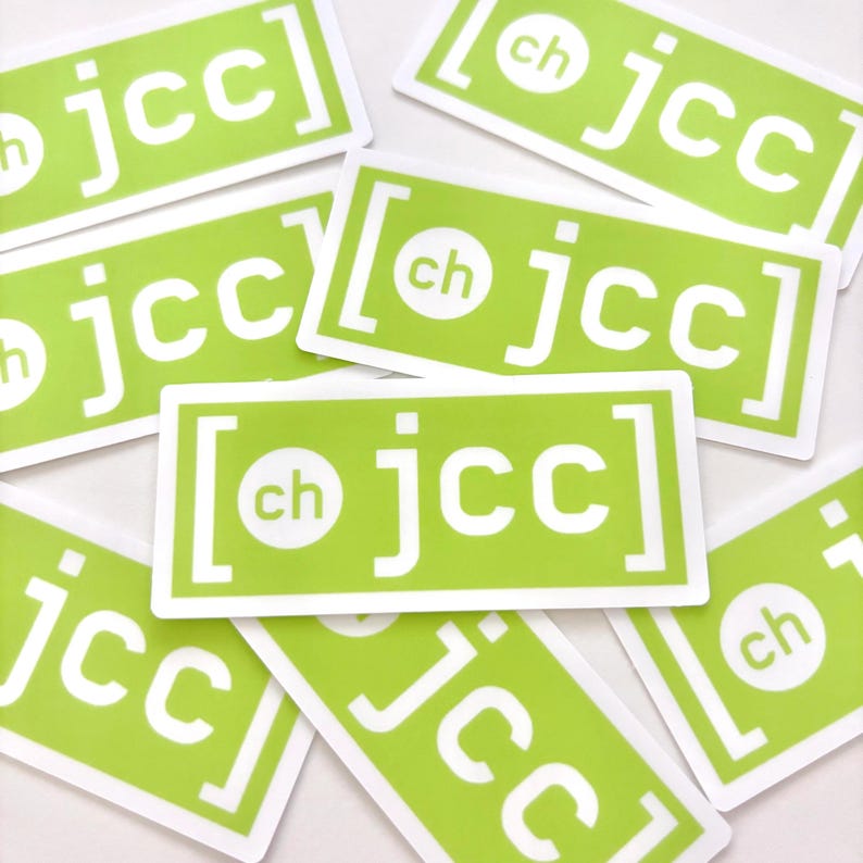 May include: A collection of rectangular stickers with a bright green background and white text. The stickers feature the letters "jcc" within a bracketed design, with "ch" in a circle. The stickers are scattered across a white surface.