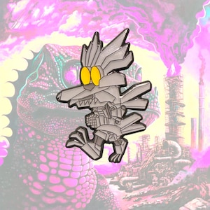 May include: A silver-colored metal enamel pin featuring a stylized, robotic wolf-like creature with large, bright yellow circular eyes, sharp angular ears, and a mechanical body design with visible segmented plating and clawed feet.
