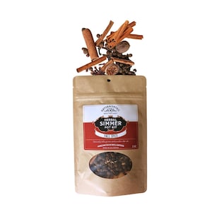 May include: A brown paper pouch containing a herbal simmer pot kit labelled Fall Spice. The label features the text Naturacentric Apothecary, Herbal Simmer Pot Kit, Fall Spice, and 2 oz. Cinnamon sticks, cloves, and nutmeg are piled on top.