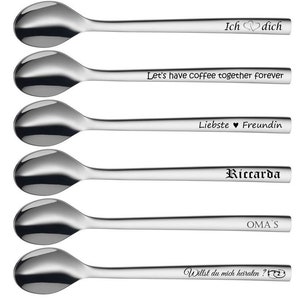 May include: Six stainless steel spoons with engraved text. The text includes phrases like "Ich dich", "Let's have coffee together forever", and "Willst du mich heiraten?". The spoons have a shiny, reflective surface.