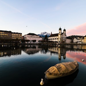 Sun rise in Lucerne, Switzerland with boat and church. Stock Photo 2021