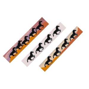 May include: Three beaded bracelets with a pattern of black horses running across a gradient background. The bracelets have a pink, white, and orange gradient.
