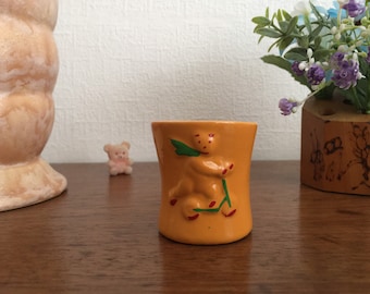 Orange Ceramic Egg Cup embossed Teddy on a scooter vintage rare