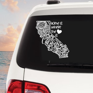 May include: White decal sticker with a black outline of the state of California with a heart and the text "Home is where the heart is California".