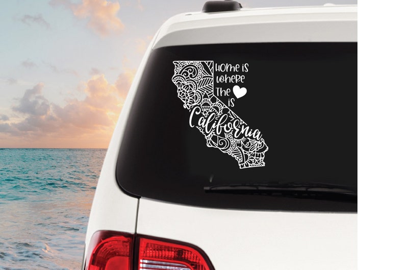 May include: White decal sticker with a black outline of the state of California with a heart and the text "Home is where the heart is California".
