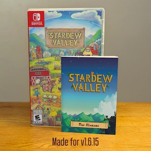 Puede incluir: Una caja de juego de video Stardew Valley con una ilustración colorida de una escena de granja. La caja está al lado de un pequeño libro azul y blanco con el título "Stardew Valley Mini Almanac" y el texto "Made for v1.6.15".