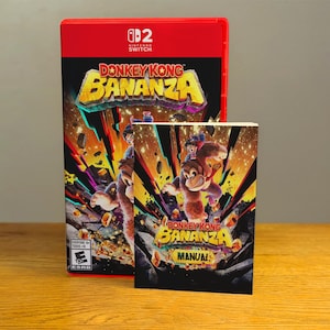 May include: A red Nintendo Switch game case and manual for "Donkey Kong Bananza." The game case features the game title in yellow and blue, with a dynamic illustration of Donkey Kong and other characters. The manual has the same artwork.