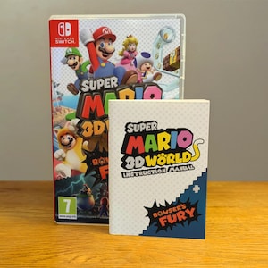 Puede incluir: Una caja de juego de Nintendo Switch con una imagen colorida de Mario, Luigi, Peach y Toad. El juego se llama "Super Mario 3D World + Bowser's Fury". El manual de instrucciones también es visible.