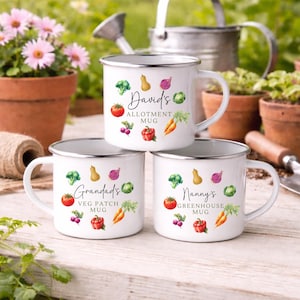 May include: Three white enamel mugs with silver rims are stacked. Each mug features a different name and the words "Allotment Mug", "Veg Patch Mug", and "Greenhouse Mug". Watercolor illustrations of vegetables decorate each mug.
