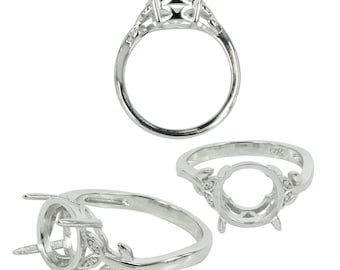 May include: Silver ring setting with a round bezel and leaf accents. The setting is designed to hold a gemstone.