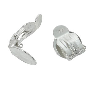 May include: A pair of silver clip-on earrings. The earrings are marked with "925" on the back.