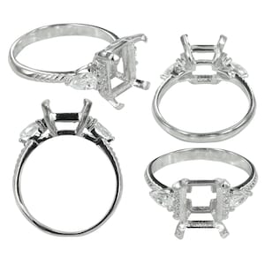 May include: A silver ring setting with a rectangular centre and side accents. The ring features a detailed band with small embellishments and pear-shaped side stones. Multiple views showcase the ring's design.