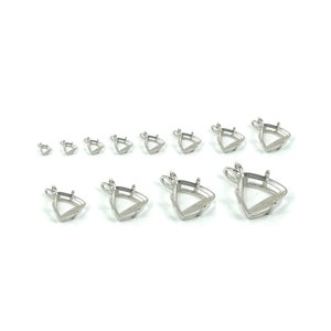 May include: A set of ten silver-toned triangle pendant settings in various sizes. The settings are designed to hold gemstones or other materials.
