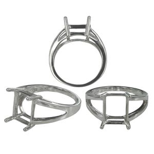 May include: A silver-coloured metal ring setting featuring a four-prong head designed to hold a rectangular gemstone. The ring is shown from three different angles, displaying the open gallery structure and the smooth, polished band construction.