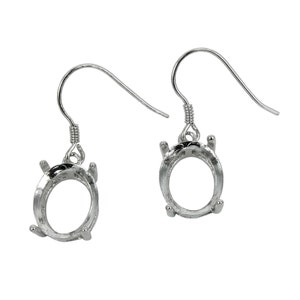 May include: Silver earring settings with a teardrop shaped bezel for a stone or gem. The settings are attached to a silver hook.