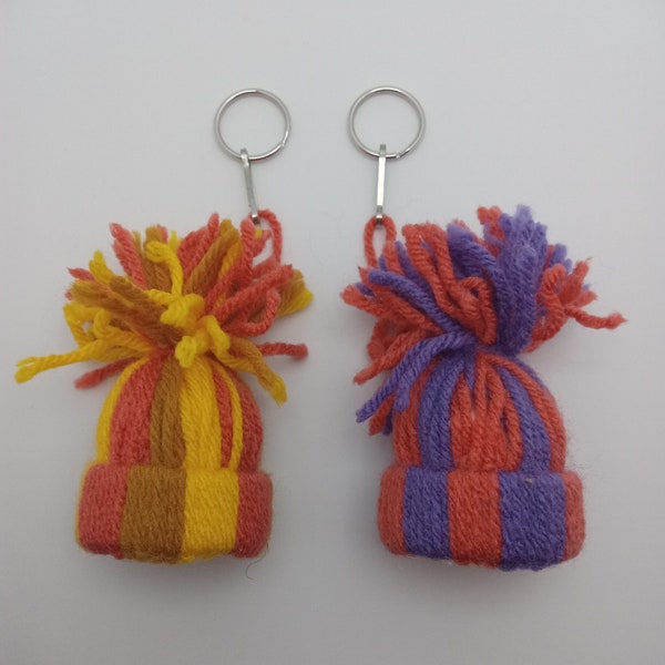 Mini beanies keychains (dark orange and purple) or (dark orange, yellow, and light brown)