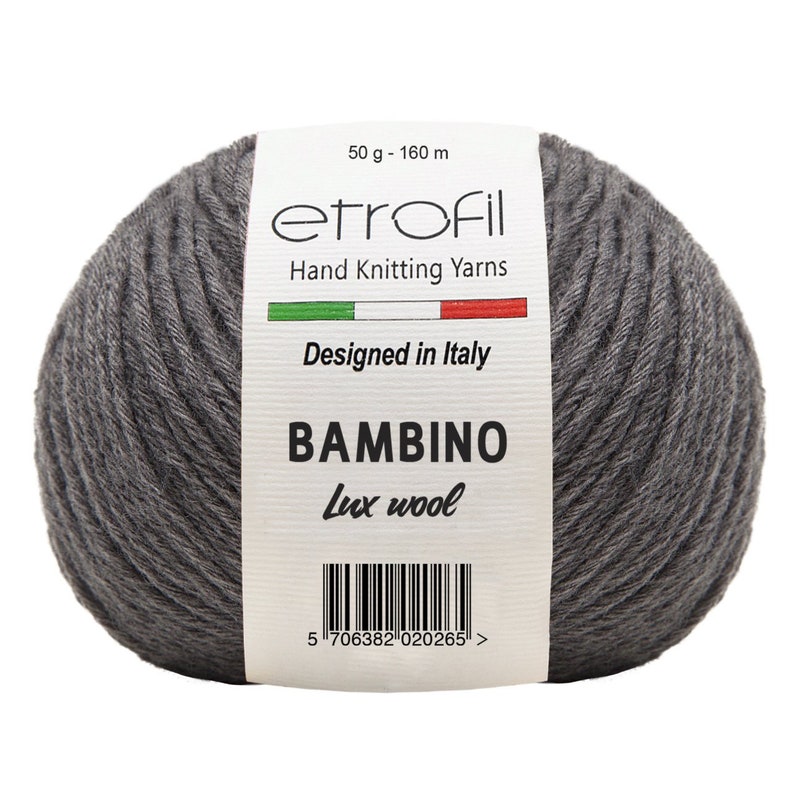 May include: A skein of gray yarn labeled "etrofil" with the text "Hand Knitting Yarns", "Designed in Italy", "BAMBINO", and "Lux wool". The label also includes a barcode and the text "50 g - 160 m".