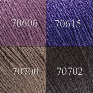 May include: Four yarn samples in different colors: a light purple, a dark purple, a light brown, and a dark gray. The yarn samples are labeled with the numbers 70606, 70615, 70700, and 70702.