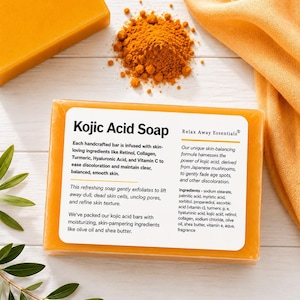 May include: A bar of Kojic Acid Soap with text, alongside a pile of turmeric powder and a folded orange cloth. The soap is infused with retinol, collagen, and vitamin C. The soap is designed to exfoliate and refine skin texture.