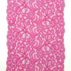 May include: Pink lace trim with a floral pattern.