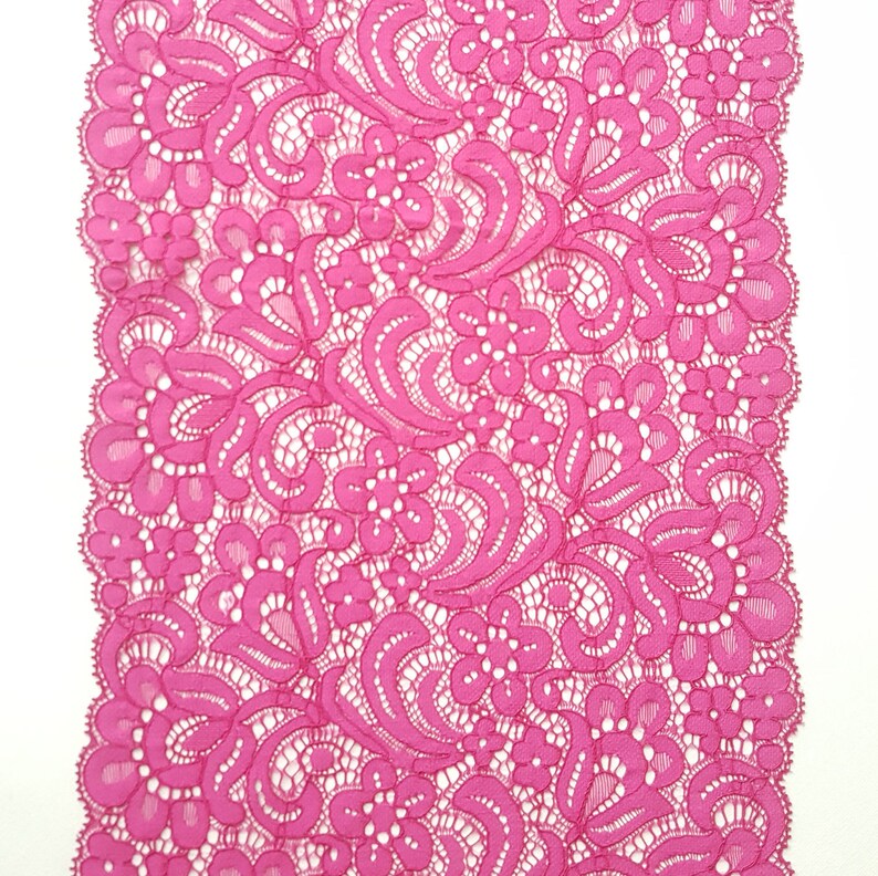 May include: Pink lace trim with a floral pattern.