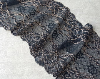May include: Black lace trim with a gold metallic floral design. The lace is delicate and has a scalloped edge.