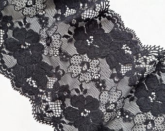 May include: Black lace trim with a floral pattern. The lace is delicate and has a scalloped edge.