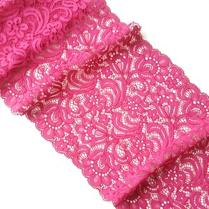 May include: Pink lace trim with a floral pattern.