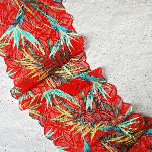 May include: Red lace trim with a tropical leaf pattern in shades of green, blue, and yellow.