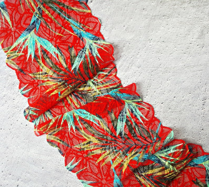 May include: Red lace trim with a tropical leaf pattern in shades of green, blue, and yellow.
