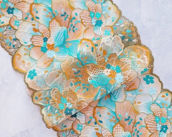 May include: Teal and orange floral lace trim with a scalloped edge. The lace is delicate and intricate, with a floral pattern.