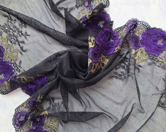 May include: Black sheer fabric with a purple and gold floral lace trim. The lace features a repeating pattern of flowers with a scalloped edge.