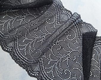 May include: Black lace trim featuring a delicate floral design. The lace is soft and stretchy, ideal for adding a touch of elegance to any project.