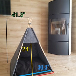 May include: A gray teepee-style pet bed with a black cushion. The bed measures 32.3 inches wide, 30.3 inches deep, and 24 inches tall. The bed is 41.3 inches high.