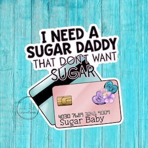 May include: A pink and blue credit card with the text "Sugar Baby" and the number "4030 7689 3241 9009". The card is surrounded by hearts and flowers. The text "I need a sugar daddy that don't want sugar" is above the card.