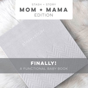 May include: A grey baby book with the text "STASH+STORY" and "FINALLY! A FUNCTIONAL BABY BOOK" printed on the cover. The book has a chevron pattern embossed on the cover.