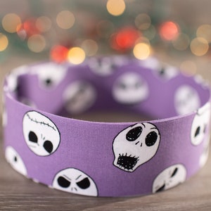 May include: Purple headband with a white repeating pattern of Jack Skellington's face from The Nightmare Before Christmas.