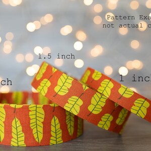 May include: Three fabric collars with a yellow and orange leaf pattern. The collars are 1 inch, 1.5 inches, and 2 inches wide. "Pattern Examples, not actual collars."