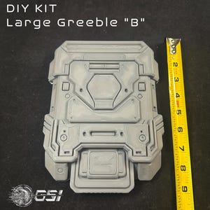 May include: A white ceramic mug with a black handle and the text "But First, Coffee" in a bold, black font. The mug is filled with a dark liquid, likely coffee, and rests on a light-coloured surface.