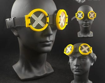 May include: Yellow and black Universal Tech Goggles with a white cross design on the lenses. The goggles are displayed on a black mannequin head. The text "SPEKT-R//V3 TYPE: A/O Universal Tech Goggles" is visible.