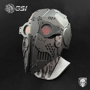 May include: A detailed, dark gray, futuristic helmet with red mesh eye coverings. The helmet features a complex, geometric design with visible screws and rivets. The GSI logo is visible on the top left, and the Antihero logo is on the bottom right.