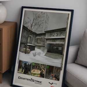 May include: Framed poster featuring a grayscale image of a Counter-Strike: Source video game scene. The poster includes the game's logo and the Steam and Valve logos. The scene depicts a snowy outdoor environment with a building and the number 52375.